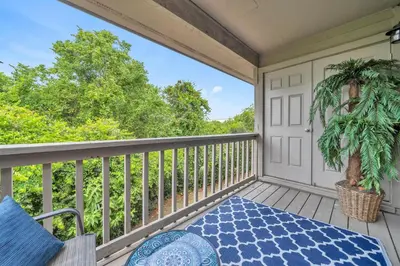 a balcony with a table and a potted plant at Cassine Gardens 112- 30A Imagine Ocean in Santa Rosa Beach
