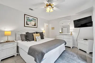 a white bedroom with a bed and a ceiling fan at Cassine Gardens 112- 30A Imagine Ocean in Santa Rosa Beach