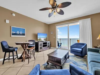 a living room with a couch and chairs and a table at Sterling Reef 1203 in Panama City Beach