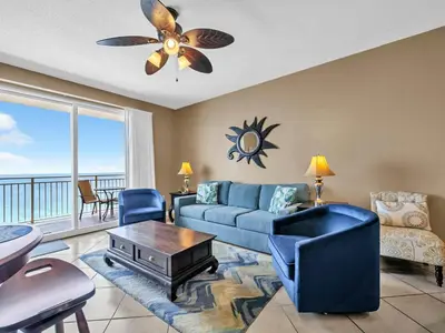 a living room with a couch and a table at Sterling Reef 1203 in Panama City Beach