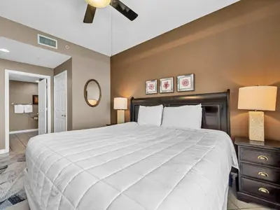 a bedroom with a large white bed and two lamps at Sterling Reef 1203 in Panama City Beach