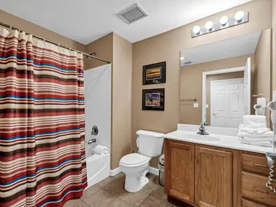 a bathroom with a toilet and a sink and a shower at Sterling Reef 1203 in Panama City Beach