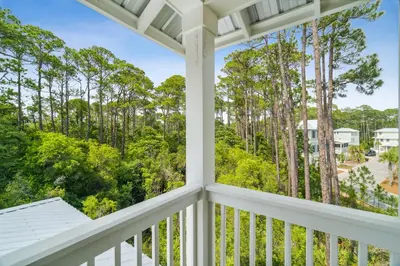 a view from the balcony of a house with trees at 30A Beach House - Wonderland at Treetop by Panhandle Getaways in Rosemary Beach