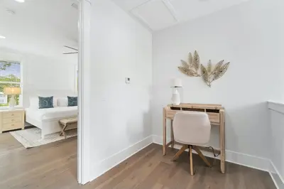 a white bedroom with a desk and a bed at 30A Beach House - Wonderland at Treetop by Panhandle Getaways in Rosemary Beach