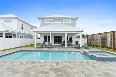 a swimming pool in front of a house at Pet Friendly Beach House - Totally Beachin by Panhandle Getaways in Panama City Beach