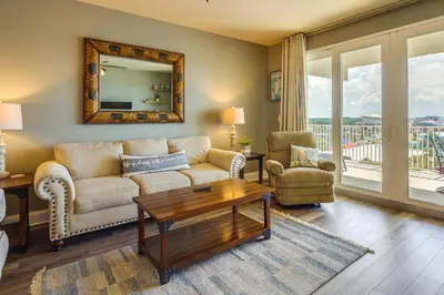 a living room with a couch and a table at PCB Vacation Rental with Balcony and Beach Access! in Panama City Beach