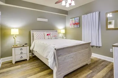 a small bedroom with a bed and a dresser at PCB Vacation Rental with Balcony and Beach Access! in Panama City Beach