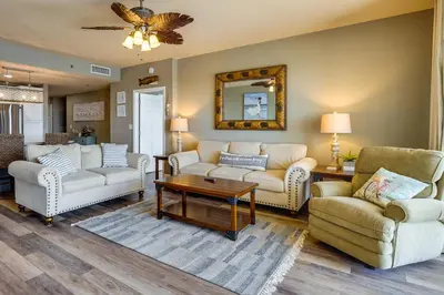 a living room with couches and a table at PCB Vacation Rental with Balcony and Beach Access! in Panama City Beach