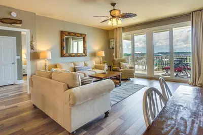a living room with a couch and a table at PCB Vacation Rental with Balcony and Beach Access! in Panama City Beach