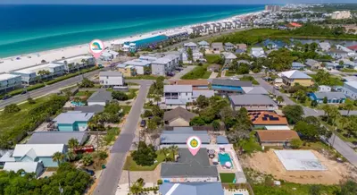 an aerial view of a beach with houses and the ocean at Steps to the beach & close to 30A! Private pool with sundeck & putt putt golf! in Panama City Beach