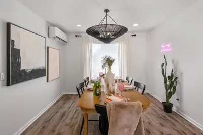 a dining room with a table and chairs at Steps to the beach & close to 30A! Private pool with sundeck & putt putt golf! in Panama City Beach