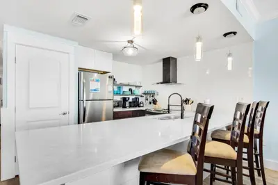 a kitchen with a white counter and a refrigerator at Boardwalk 209 in Panama City Beach