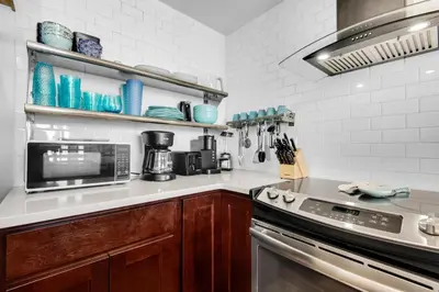 a kitchen with a stove and a microwave at Boardwalk 209 in Panama City Beach