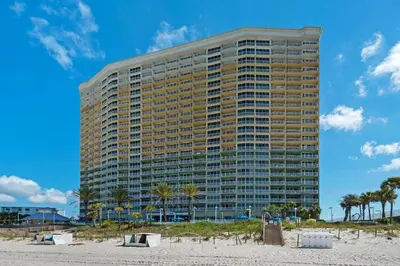 a tall building on the beach next to the beach at Boardwalk 209 in Panama City Beach