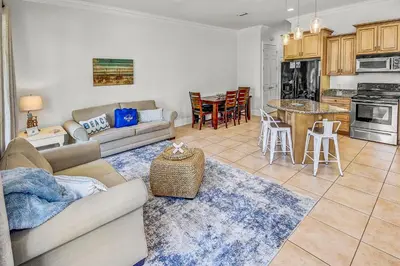 a living room with a couch and a table at 136 La Valencia Cir - At Peace in Panama City Beach