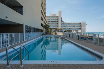 a swimming pool on the side of a building at Ocean Reef 1106 - Lazy Daze in Panama City Beach