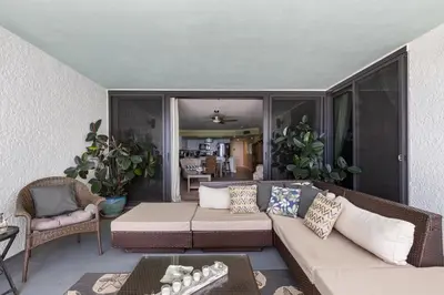 a living room with a couch and a table at Stunning 2/2 Designer Condo w Coastal Appeal Right on the Gulf! in Panama City Beach