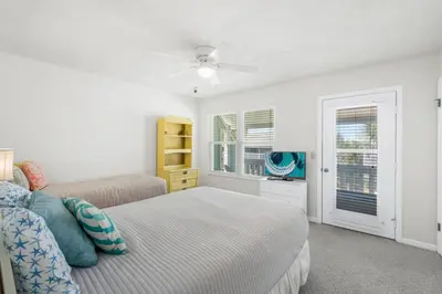 a white bedroom with a bed and a window at NEW! Steps To White Sand Beaches! Pool & Grill! 2BR 2BA in Panama City Beach