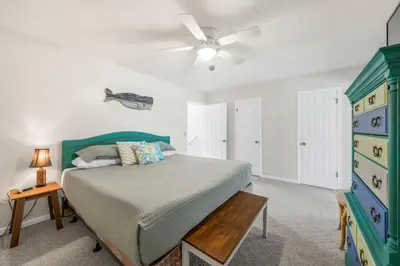 a bedroom with a bed and a ceiling fan at NEW! Steps To White Sand Beaches! Pool & Grill! 2BR 2BA in Panama City Beach
