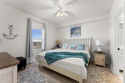 a bedroom with a bed and a ceiling fan at Luxury Gulf-View 3BD Condo! Free Beach Chairs! by Dolce Vita Getaways PCB in Panama City Beach