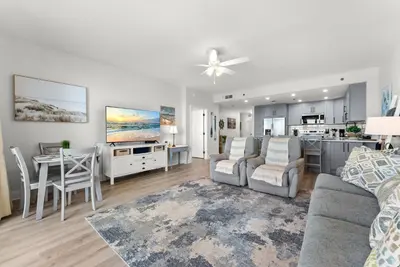 a living room with a couch and a table at Luxury Gulf-View 3BD Condo! Free Beach Chairs! by Dolce Vita Getaways PCB in Panama City Beach