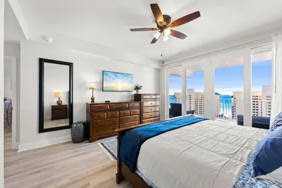 a bedroom with a bed and a ceiling fan at Luxury Gulf-View 3BD Condo! Free Beach Chairs! by Dolce Vita Getaways PCB in Panama City Beach