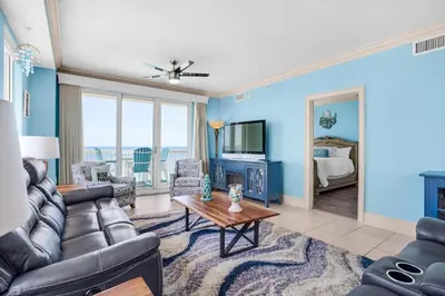 a living room with a couch and a tv at Seychelles 1601 in Panama City Beach