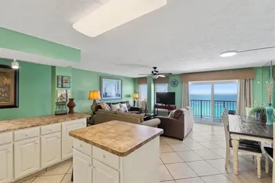 a kitchen and living room with a view of the ocean at The Summit 1512 in Panama City Beach