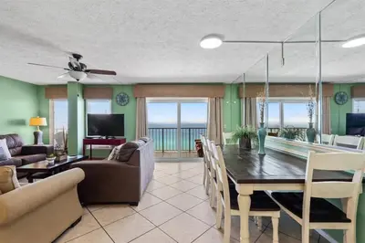a dining room and living room with a table and chairs at The Summit 1512 in Panama City Beach