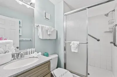 a white bathroom with a shower and a sink at The Summit 1512 in Panama City Beach