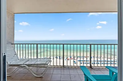 a balcony with a bench and a view of the beach at The Summit 1512 in Panama City Beach