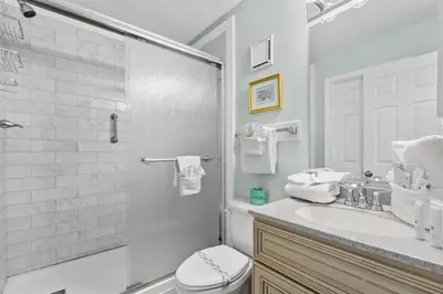 a bathroom with a toilet and a sink and a shower at The Summit 1512 in Panama City Beach