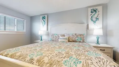 a bedroom with a large bed with two lamps at Beachfront - Beach Chairs Included! - FLPCB53 in Panama City Beach