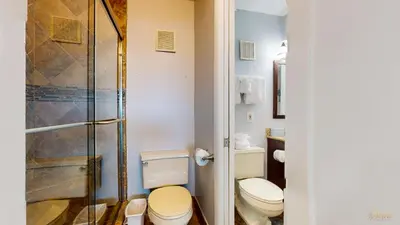 a bathroom with two toilets and a shower at Beachfront - Beach Chairs Included! - FLPCB53 in Panama City Beach