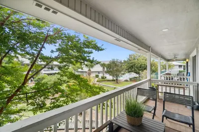 a balcony with two benches and a view of the street at 30A Beachwood Villas by Panhandle Getaways in Santa Rosa Beach