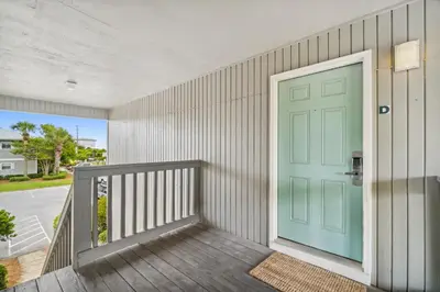 a green door on a house with a porch at 30A Beachwood Villas by Panhandle Getaways in Santa Rosa Beach