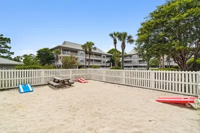 a beach with a white fence and a picnic table at 30A Beachwood Villas by Panhandle Getaways in Santa Rosa Beach