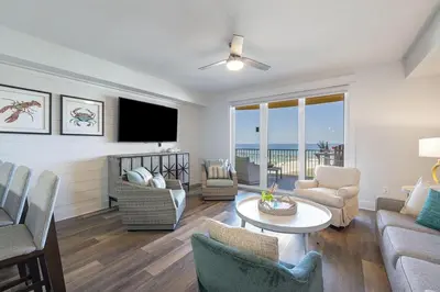 a living room with a couch and chairs and a television at Calypso 3-903 - Emerald Getaway in Panama City Beach