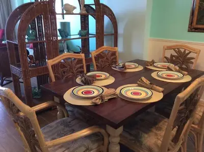 a wooden table with plates and napkins on it at Panama City Beach Condo at Sunrise Resort in Panama City Beach