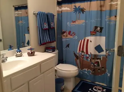 a bathroom with a sink and a toilet and a shower curtain at Panama City Beach Condo at Sunrise Resort in Panama City Beach