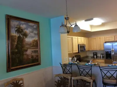 a kitchen with a painting hanging on the wall at Panama City Beach Condo at Sunrise Resort in Panama City Beach