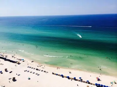 an aerial view of a beach with people in the water at Panama City Beach Condo at Sunrise Resort in Panama City Beach