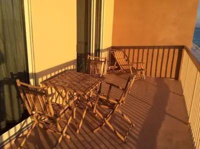 two wicker chairs and a table on a balcony at Panama City Beach Condo at Sunrise Resort in Panama City Beach