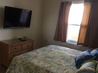 a bedroom with a bed and a flat screen tv at Panama City Beach Condo at Sunrise Resort in Panama City Beach