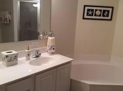 a bathroom with a sink and a bath tub at Panama City Beach Condo at Sunrise Resort in Panama City Beach