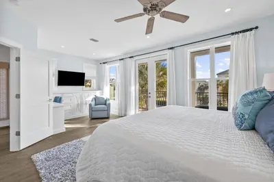 a white bedroom with a large bed with a ceiling fan at Peaceful Easy Feeling - 156 Chivas Lane, Unit B home in Santa Rosa Beach