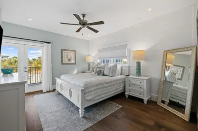 a bedroom with a bed with a ceiling fan and a mirror at Peaceful Easy Feeling - 156 Chivas Lane, Unit B home in Santa Rosa Beach