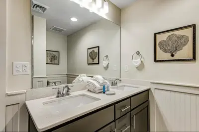 a bathroom with two sinks and a large mirror at Calypso Resort Tower 3 Unit 711 in Panama City Beach