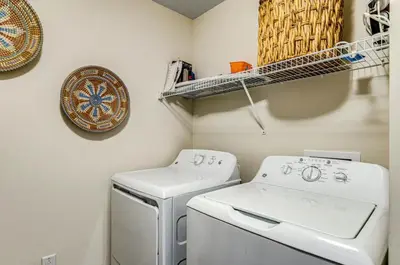 a laundry room with a washer and dryer at Calypso Resort Tower 3 Unit 711 in Panama City Beach
