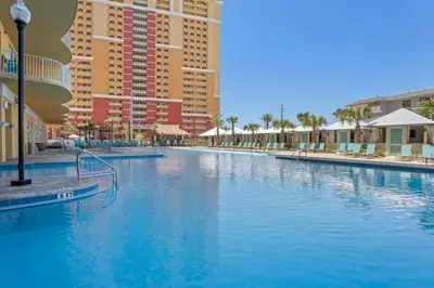 a large swimming pool in a resort with tall buildings at Calypso Resort Tower 3 Unit 711 in Panama City Beach